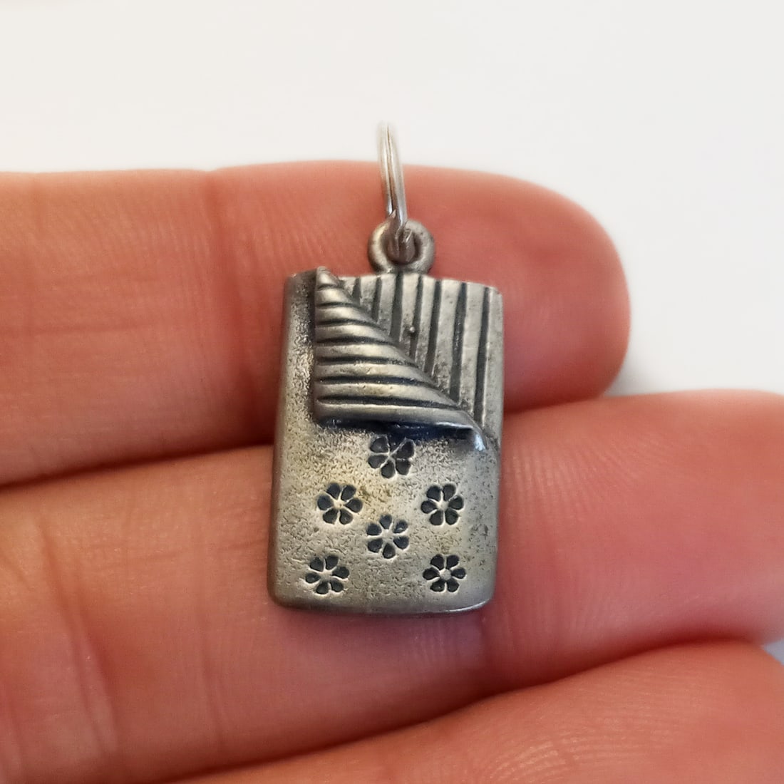 Sterling silver Slumber Party sleeping bag charm: Sterling silver Slumber Party sleeping bag charm. Weight 4.93 grams. Length 1 inch with bail. No hallmark, tested 925. Condition very good.