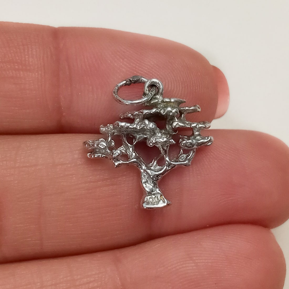 Sterling silver Bonsai Tree charm: Sterling silver Bonsai Tree charm pendant. Weight 1.62 grams. Length 7/8 inches with bail. No hallmark, tested 925 sterling silver. Condition very good.