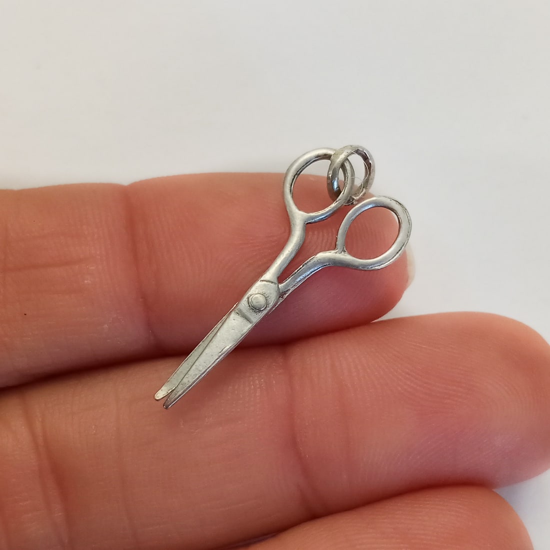 Vintage sterling silver scissors charm: Vintage sterling silver scissors charm. Weight 0.66 grams. Length 1 inch with bail. No hallmark, tested 925 sterling silver. Condition very good.