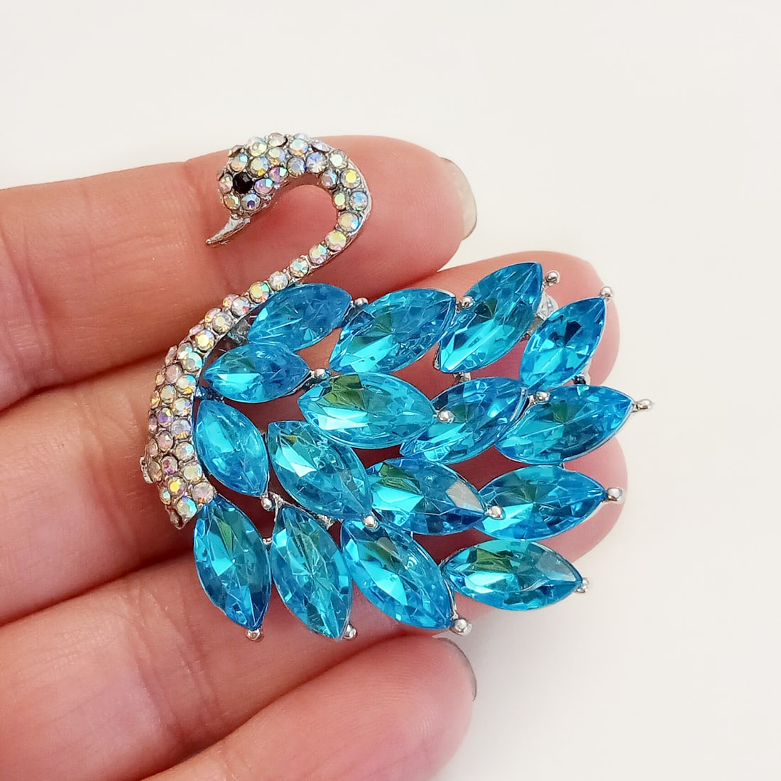 Silver tone iridescent, marquise shape blue rhinestones Swan bird brooch: Silver tone iridescent, marquise shape blue rhinestones Swan bird brooch. Measured 1 5/8 x 1 5/8 inches. Condition excellent.