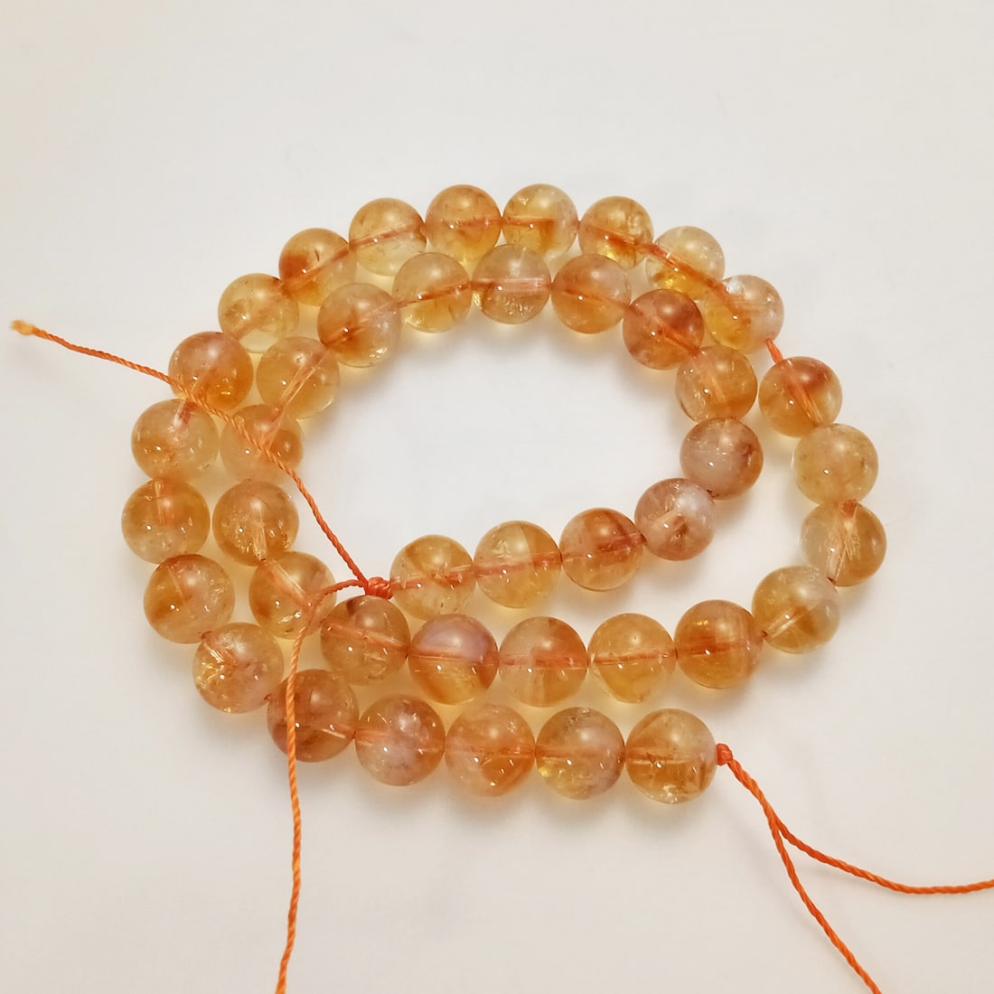 10 mm round shape Citrine beads strand: 10 mm round shape Citrine beads strand. Total weight of strand approximately 280 cts. Strand length approximately 15 1/2 inches. Beads measured 10 mm in diameter.