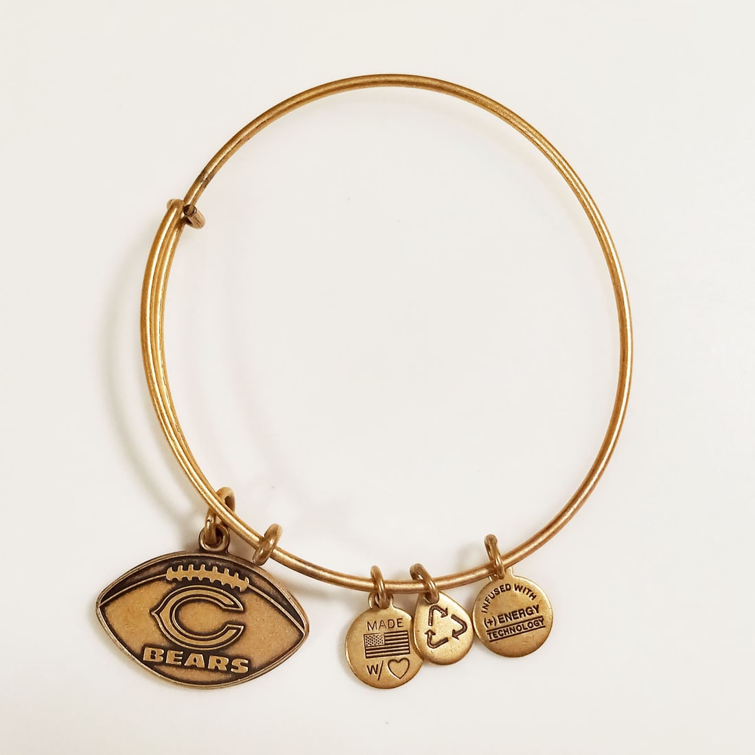 ALEX and ANI Gold tone NFL Chicago Bears bracelet: ALEX and ANI Rafaelian Gold tone NFL Football shape Chicago Bears charm expandable bracelet. Hallmarked Made in USA with Love, Infused with + energy technology, Alex and Ani. Condition very good.