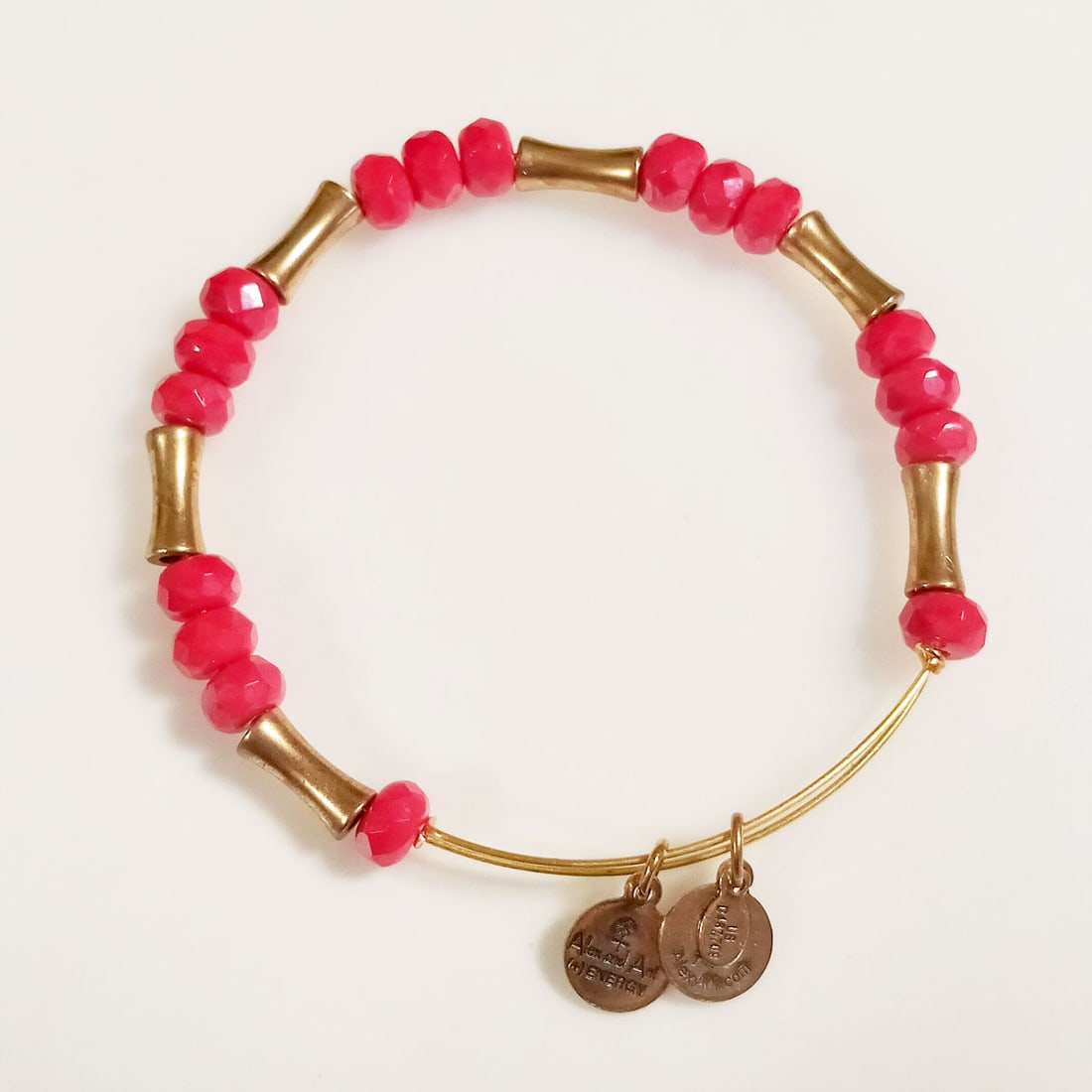 ALEX and ANI Gold tone red faceted beads bracelet: ALEX and ANI Rafaelian Gold tone bamboo shape beads and red faceted beads expandable bracelet. Hallmarked Made in USA with Love, Infused with + energy technology, Alex and Ani. Condition very good.