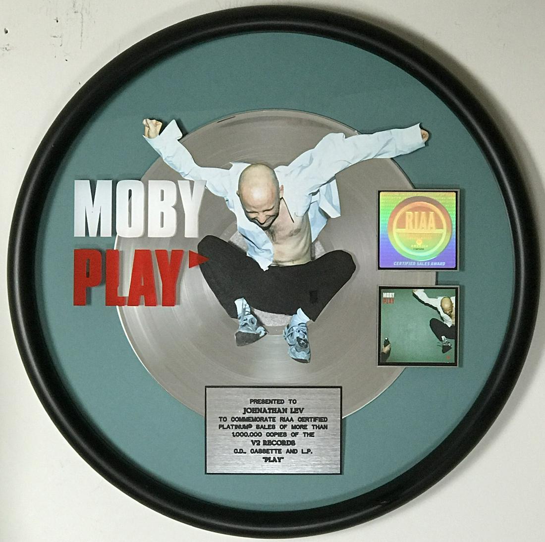 Moby Play RIAA Platinum LP Award: Here's a unique RIAA Platinum Album award for your collection. Moby's Play was released on May 17, 1999 and was certified Platinum by the RIAA on June 2, 2000 for one million copies sold. This circula