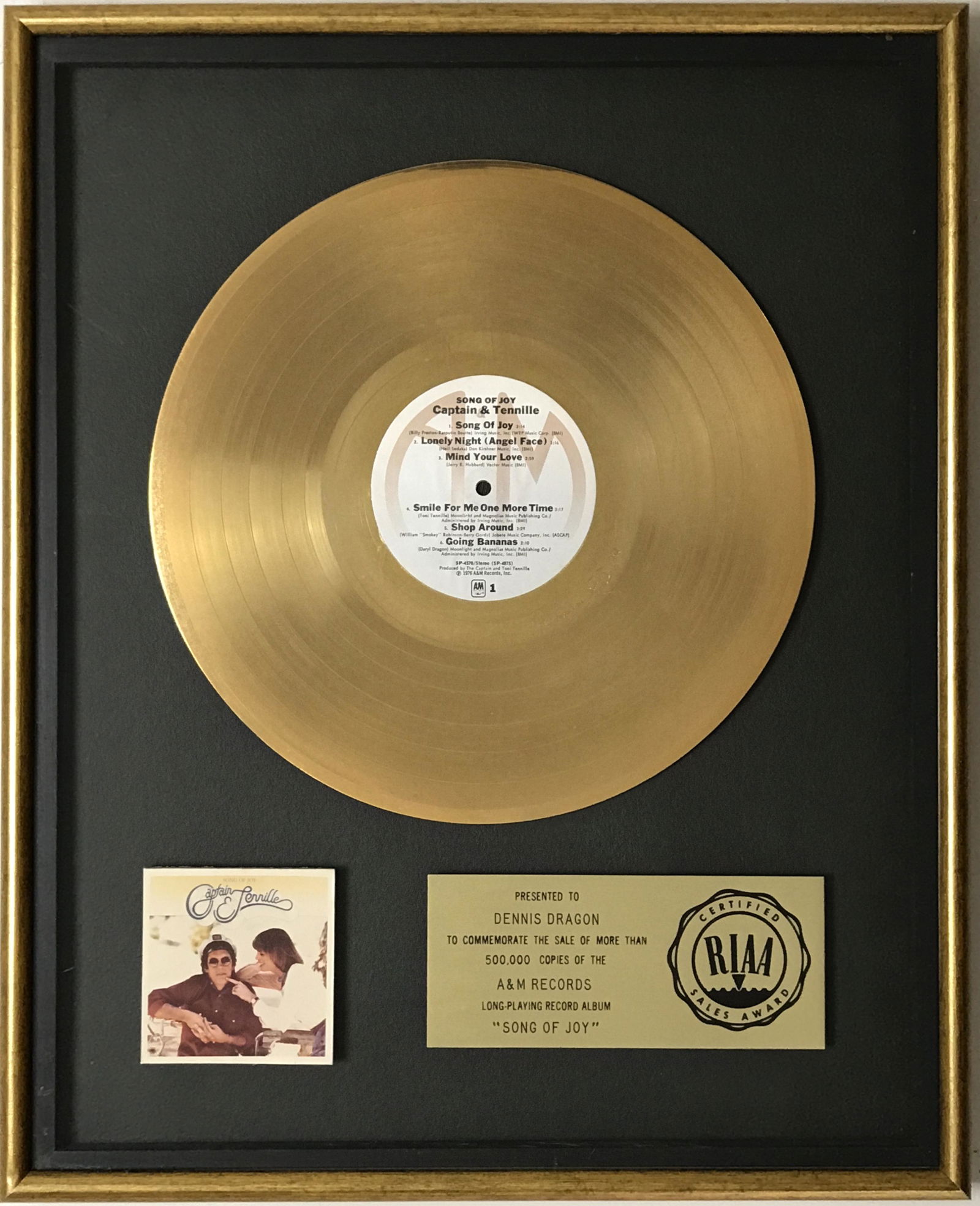 Captain & Tennille Song Of Joy RIAA Gold LP Award: RIAA Gold album award for Captain & Tennille's album Song Of Joy. Released on Feb. 27, 1976, the album was quickly certified Gold by the RIAA on March 10, 1976 for 500,00