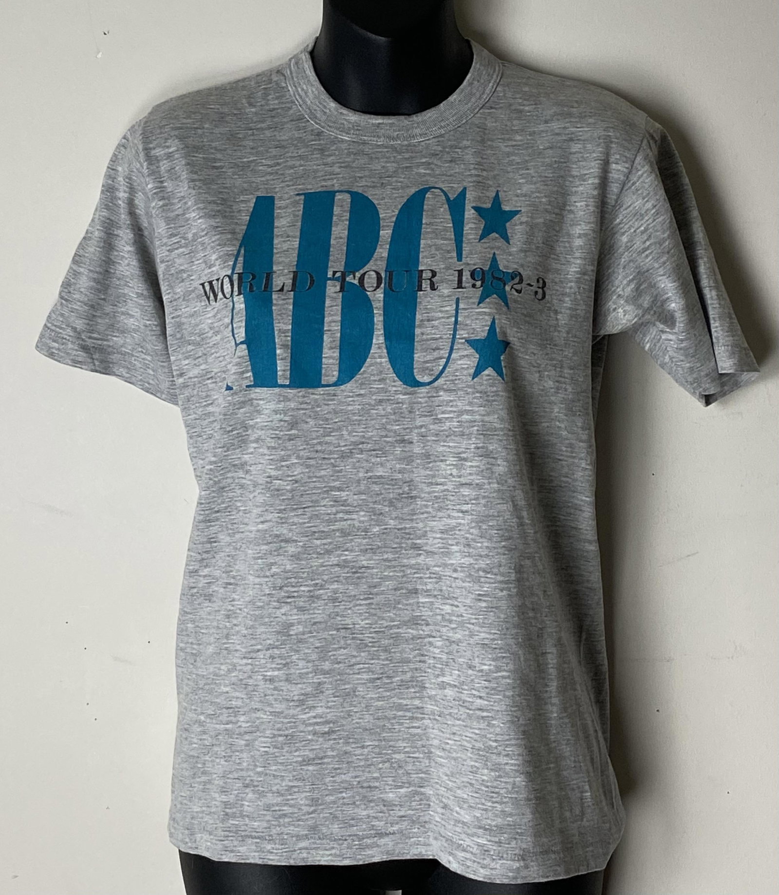 ABC World Tour 1982-83 Vintage T-shirt: Awesome ABC World Tour 1982-83 t-shirt! ABC band logo covers the front of the shirt. The t-shirt is a lightweight t-shirt in gray. There is no tag - the shirt is a Women's S/M. This t-shirt 