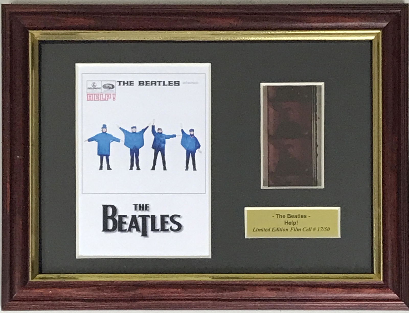 Beatles Help! Film Cel Collage: Unique piece! Beatles Help! genuine film cel, framed in a small collage. Featuring iconic image from the film. Framed in a special open-design floater frame with a clear back and front, this small col