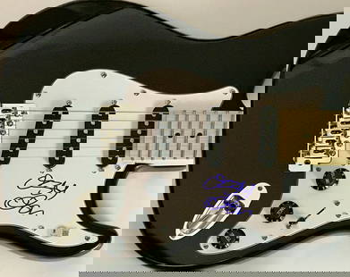 Ozzy Osbourne Signed Black Guitar w/BAS COA: Black guitar signed by Ozzy Osbourne, hard rock legend as a solo artist and member of Black Sabbath. Signed by the "Prince Of Darkness" in blue felt tip pen, this full-size red guitar comes with QR co