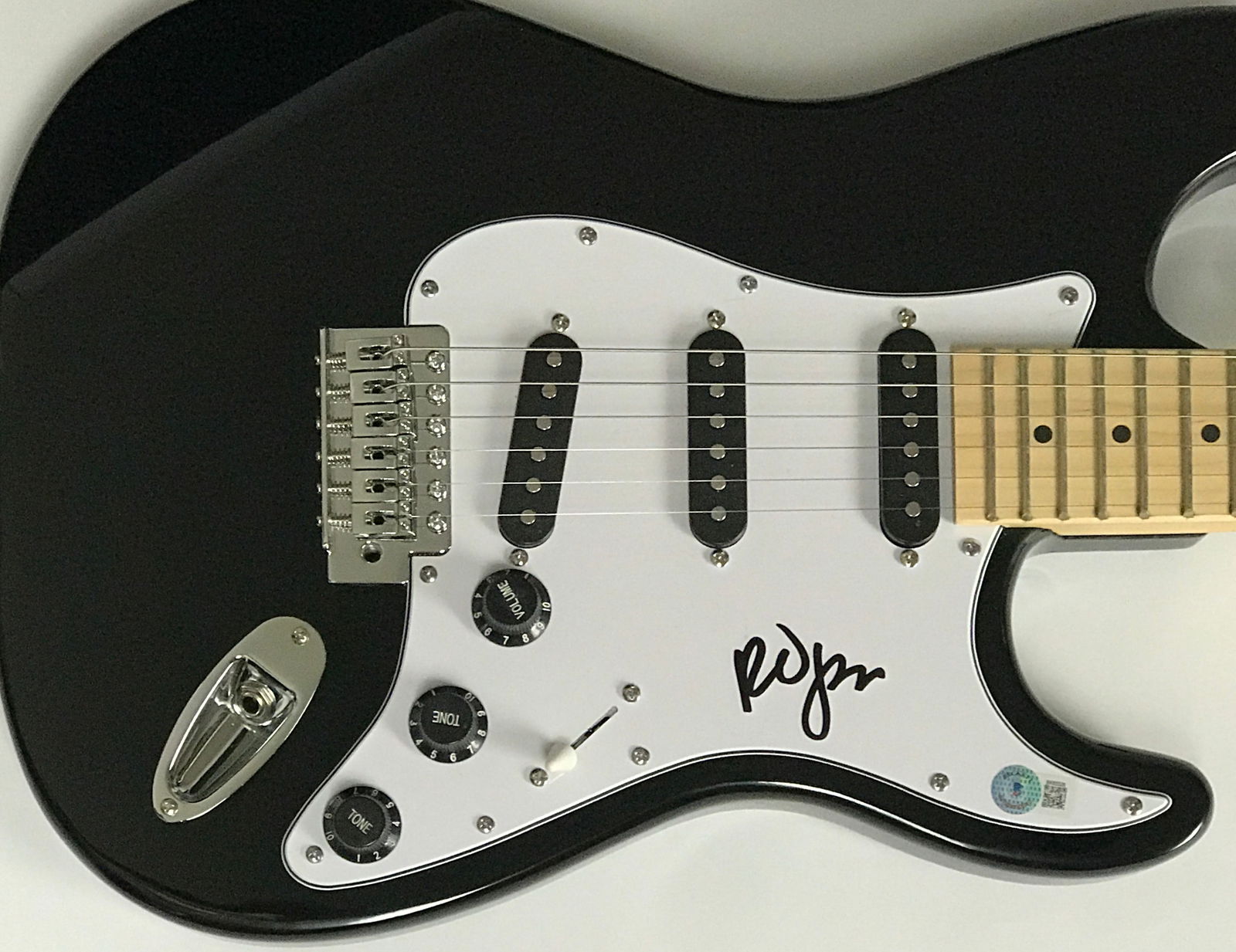 The Cure Robert Smith Signed Guitar w/BAS COA: Black guitar signed by lead singer/guitarist and founder of The Cure, Robert Smith. Signed by the Smith in black marker, this full size black guitar comes with a QR code certificate of authenticity fr