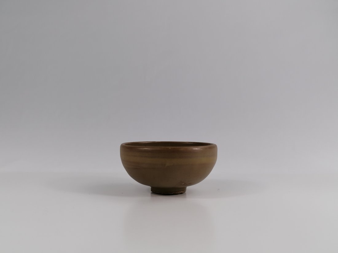 A Chinese Cizhou Type bowl: 14/15th century, a delicately potted bowl of Cizhou type, with russet markings across the well and of the mottled dark brown on the upper exterior walls, the unglazed surface of the lower walls and fo