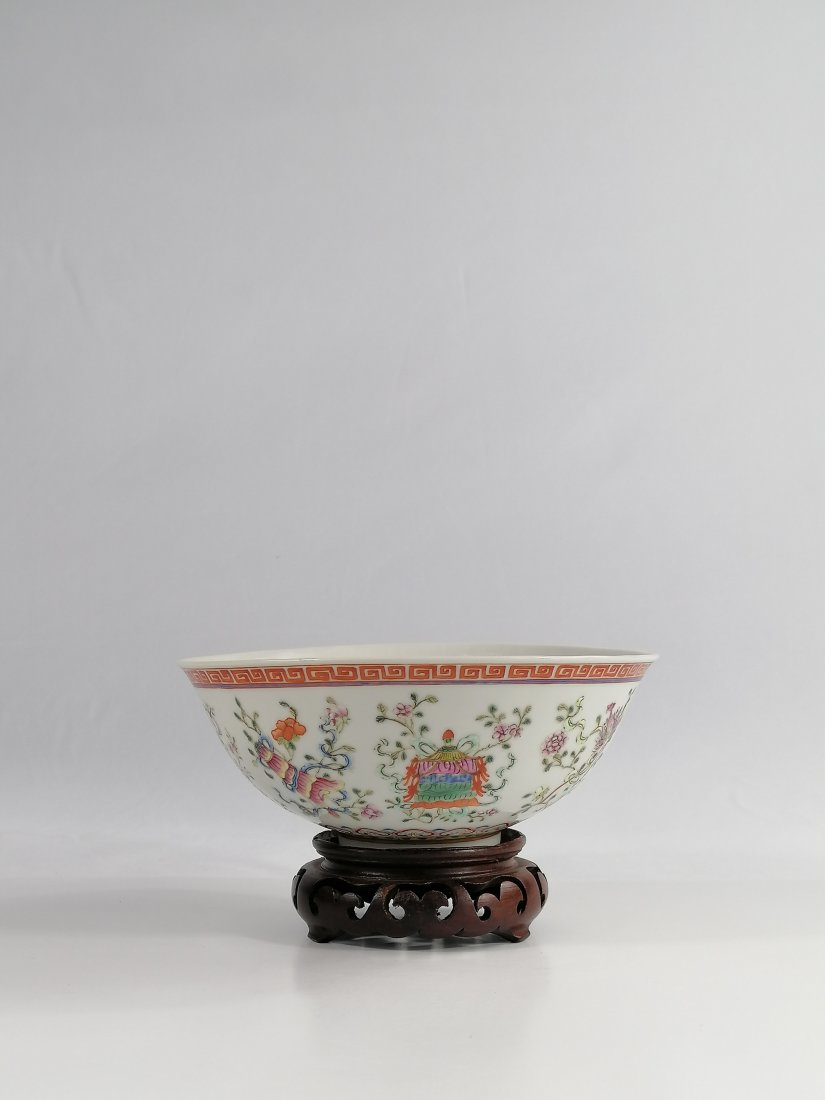 A Chinese Famille Rose Bowl: 19th century Qing dynasty Guangxu Six-character mark in underglaze blue and of the period. The exterior is decorated with the ‘Eight Buddhist Emblems’ between borders of iron-red key fret and upri