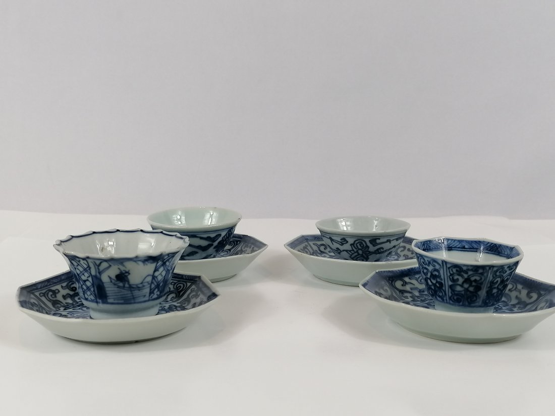 A group of blue and white porcelain tea set: Qing dynasty, Qianlong Period, octagon shaped saucers, decorated with lotus and leaves branches, Diameter 10.2cm, two cups have round rim, one has octagon rim, together with a flower rim decorated wit
