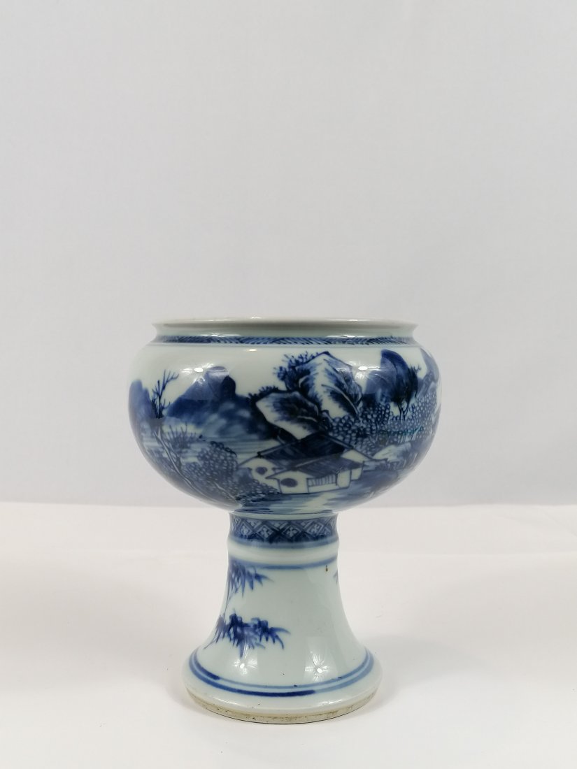 A Blue and white porcelain Dou: 18th century Chinese Qing dynasty, a rare piece, with high foot decorated bamboo, upper pot part decorated continues river and mountain-scape. Height:14.5cmProvenance: Ralph M.Chait Galleries of New Y
