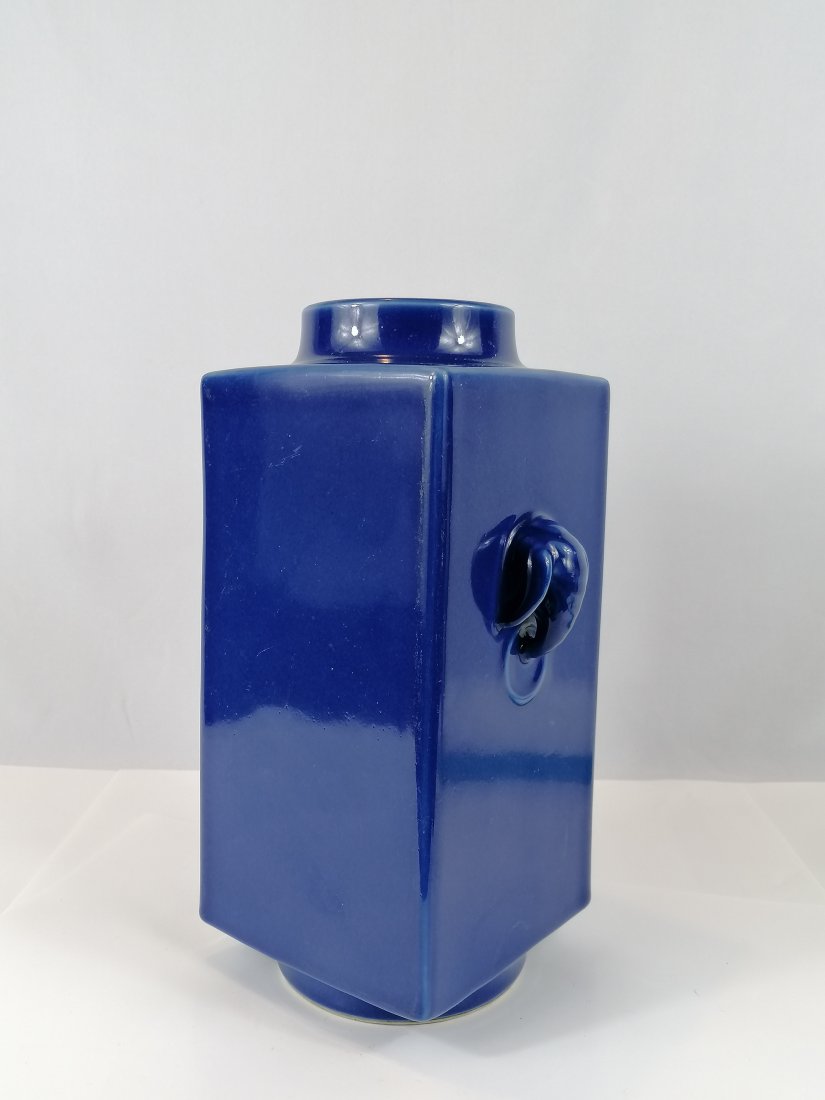 A Fine Blue-Glazed Square vase Cong: Qing dynasty Tongzhi Marked and period.The rectangular body of archaistic form with characteristic circular foot ring and mouth rim, applied with a pair of moulded elephant-heads, each suspending a mo