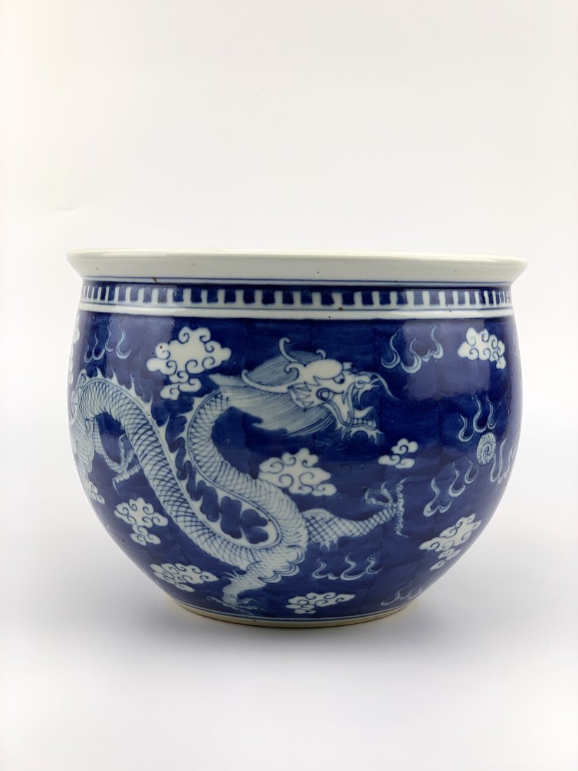 Chinese Blue & White Fish Bowl: 19/20th centurywith a design of Dragons and Clouds, the top border with pearls. Diameter.25.3cm Height 19cm