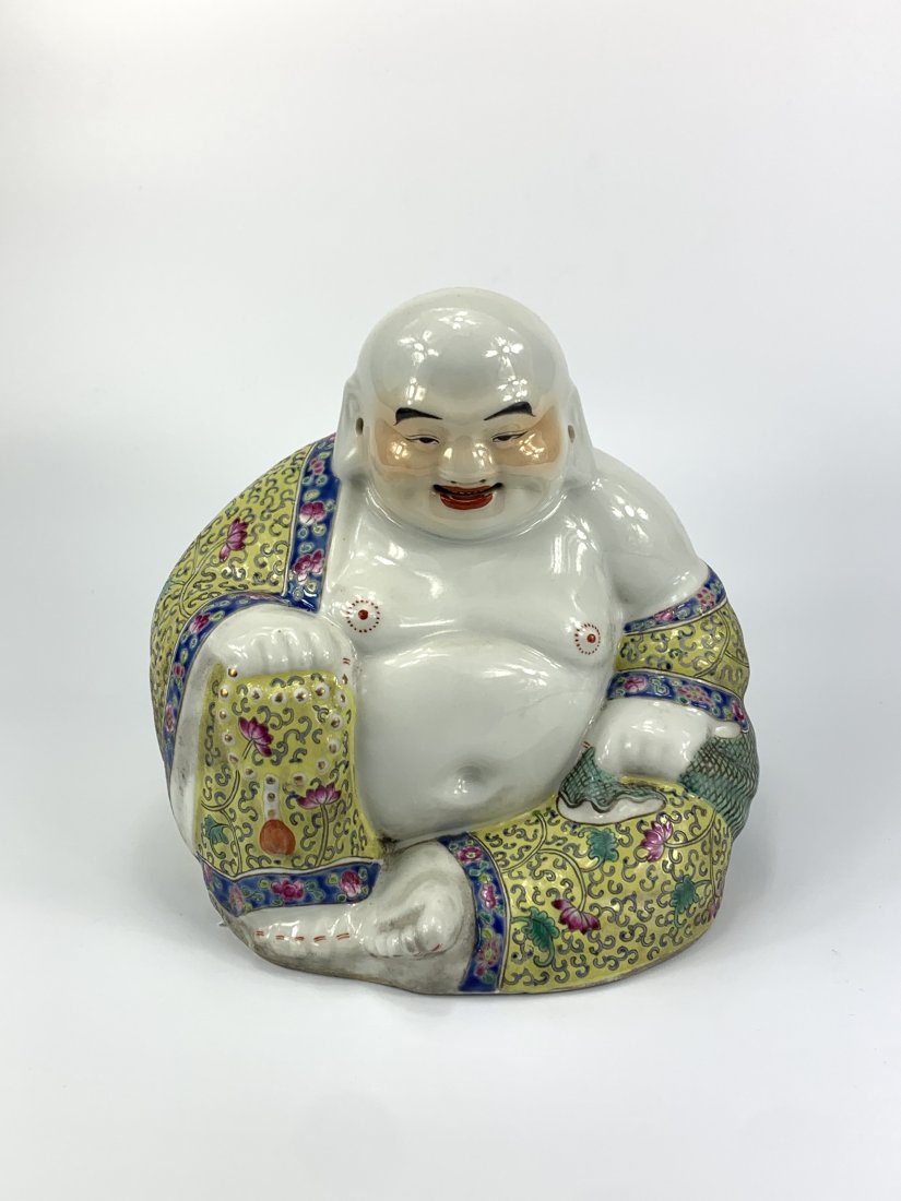 A Chinese famille rose Budai Buddha: Republic period, Chinese famille rose porcelain figures of Buddha in yellow ground robe Dimensions:Height 23cm.In Good Condition