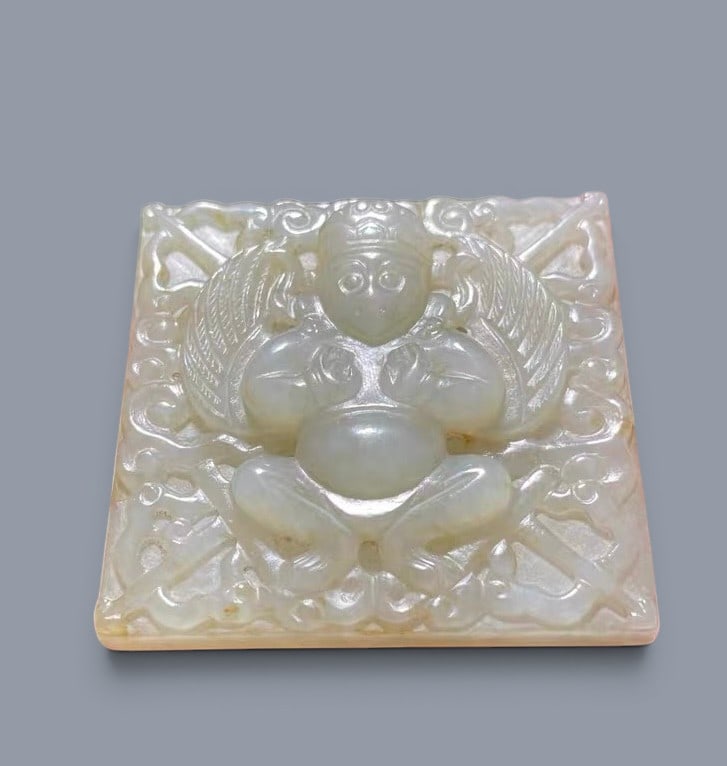 Chinese Art, A Jade Plaque Carved with a Garuda, 16th-18th Century, Qing Dynasty: Chinese Art, A Jade Plaque Carved with a Garuda, 16th-18th Century, Qing Dynasty, Height 4.9 cm, Width 4.6 cm, Thickness 0.58 cm.