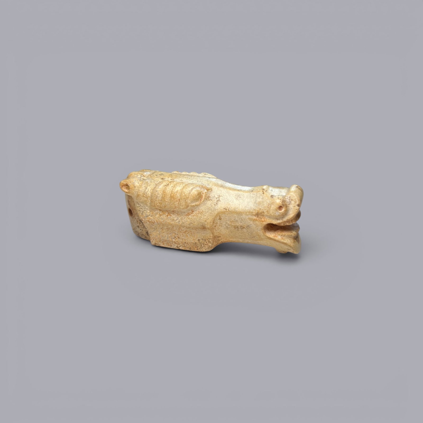 Chinese Art, A Jade Horse Head, 3rd Century BC-3rd Century AD, Han Dynasty: Chinese Art, A Jade Horse Head, 3rd Century BC-3rd Century AD, Han Dynasty, Height 1.7 cm, Length 4.8 cm.