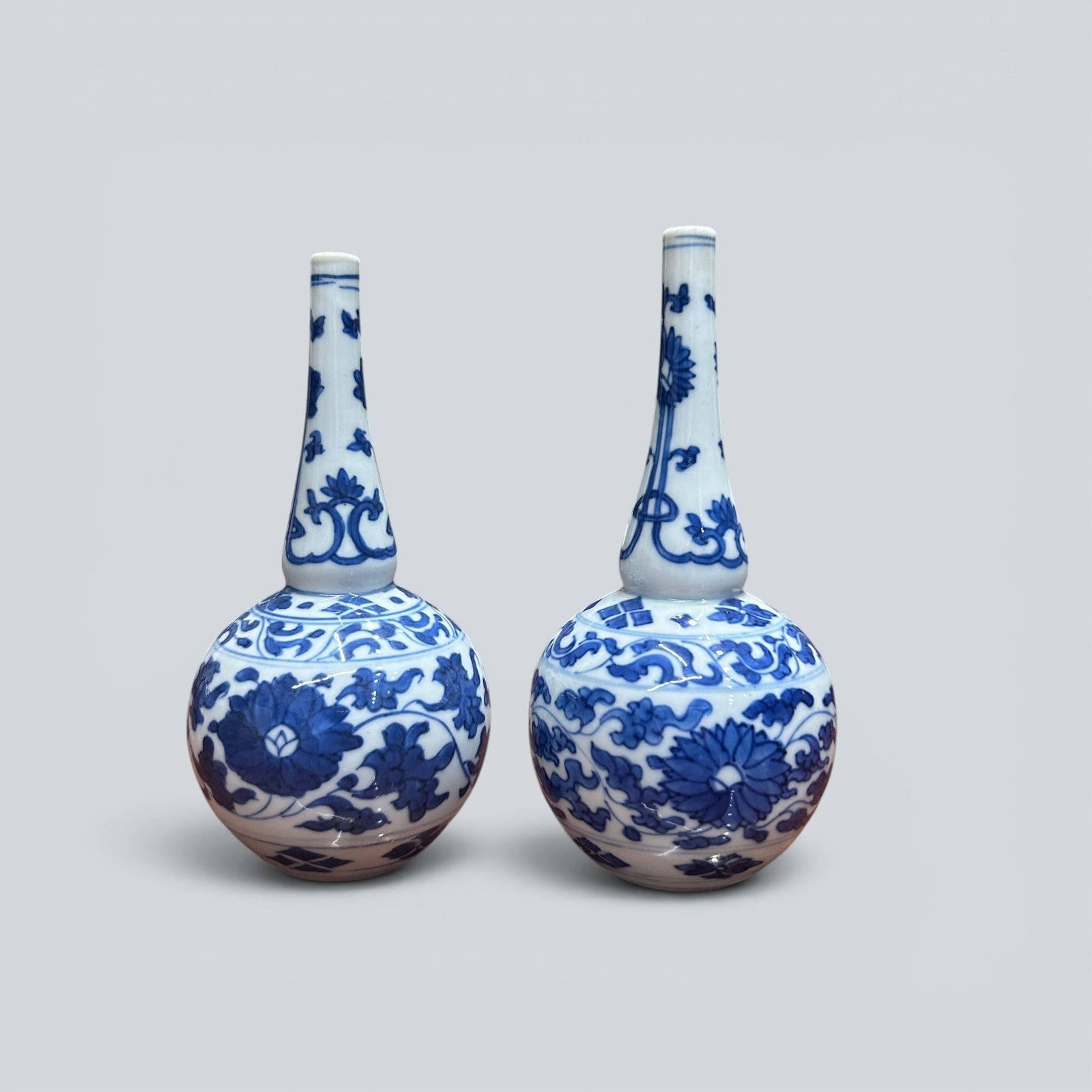 Chinese Art, A Group of Two Blue and White Vases Decorated with Floral Motifs, 17th Century, Qing: Chinese Art, A Group of Two Blue and White Vases Decorated with Floral Motifs, 17th Century, Qing Dynasty, Heights 15 cm and 15.5 cm .