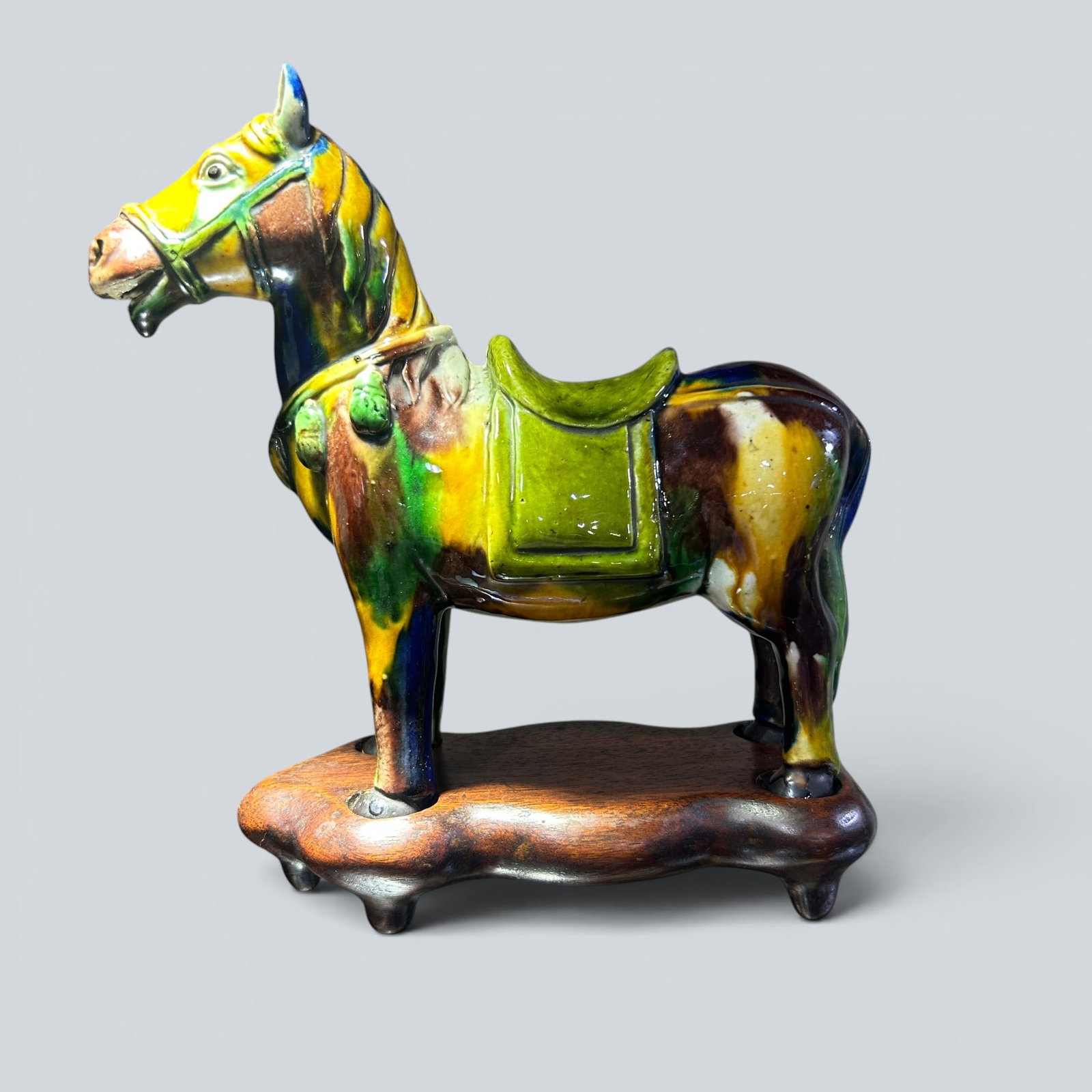 Chinese Art, A Sancai Glazed Horse Figure, 19th Century, Qing Dynasty: Chinese Art, A Sancai Glazed Horse Figure, 19th Century, Qing Dynasty, Height 21 cm, Width 21 cm.