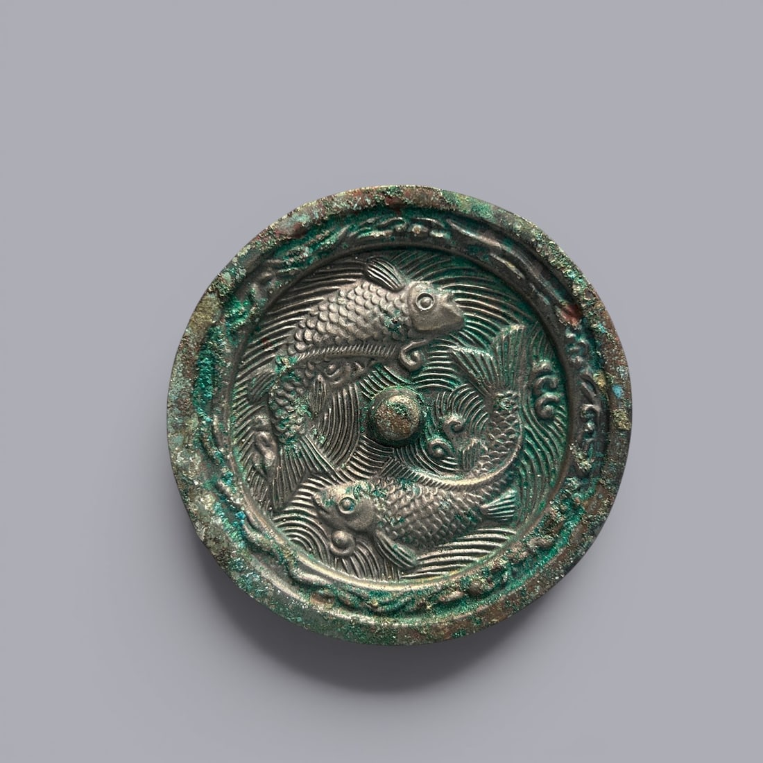 Chinese Art, A Bronze Mirror Decorated with Twin Fish Motifs, 8th-10th Century, Tang Dynasty: Chinese Art, A Bronze Mirror Decorated with Twin Fish Motifs, 8th-10th Century, Tang Dynasty, Diameter 9.5 cm.