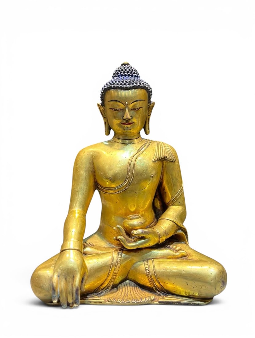 Himalayan Art, Tibet, A Gilt-Bronze Figure of Shakyamuni Buddha, 16th-18th Century: Himalayan Art, Tibet, A Gilt-Bronze Figure of Shakyamuni Buddha, 16th-18th Century, Height 26 cm.