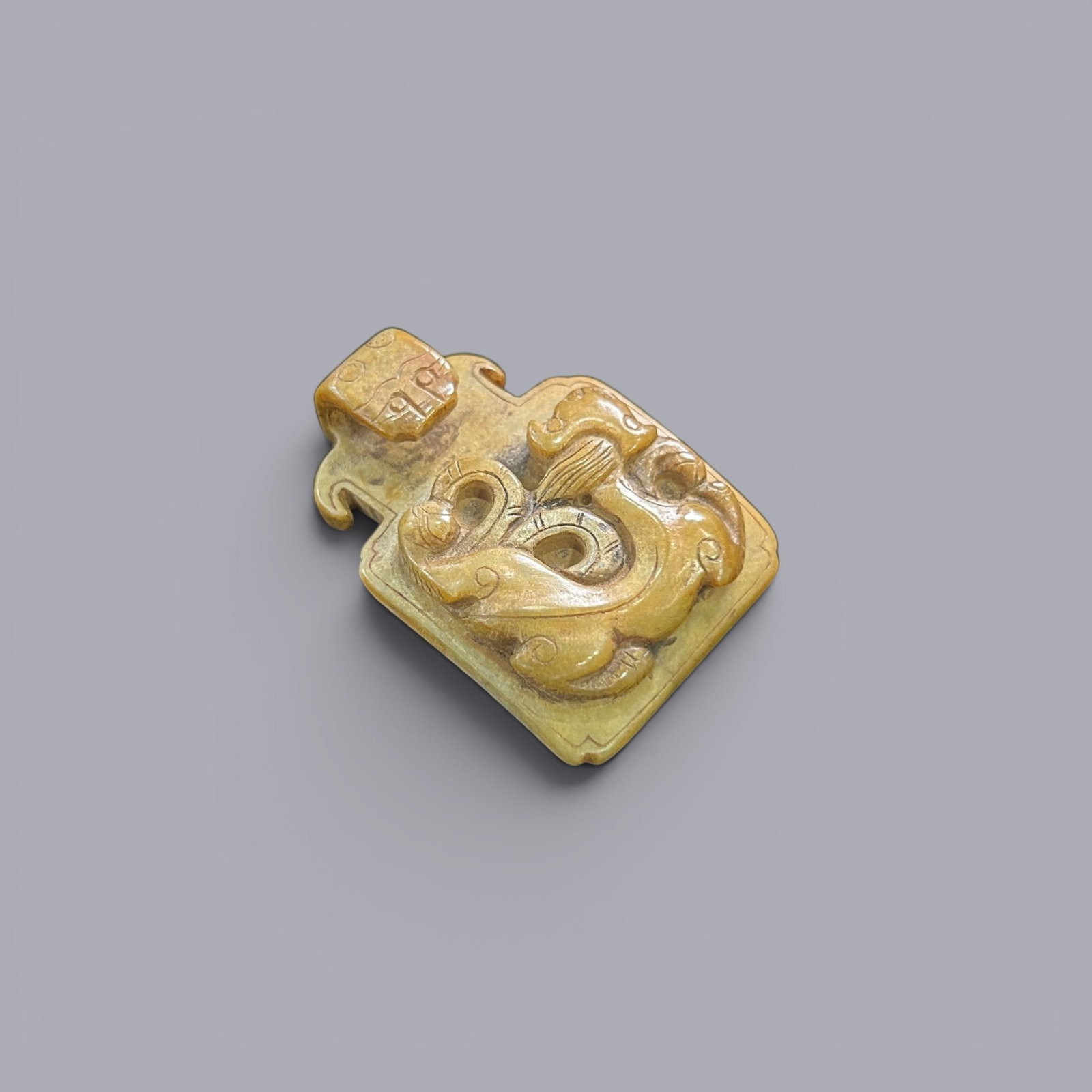 Chinese Art, A Jade Belt Hook Decorated with Dragons, 3rd Century BC-3rd Century AD, Han Dynasty: Chinese Art, A Jade Belt Hook Decorated with Dragons, 3rd Century BC-3rd Century AD, Han Dynasty, Length 5.3 cm, Width 3.7 cm.