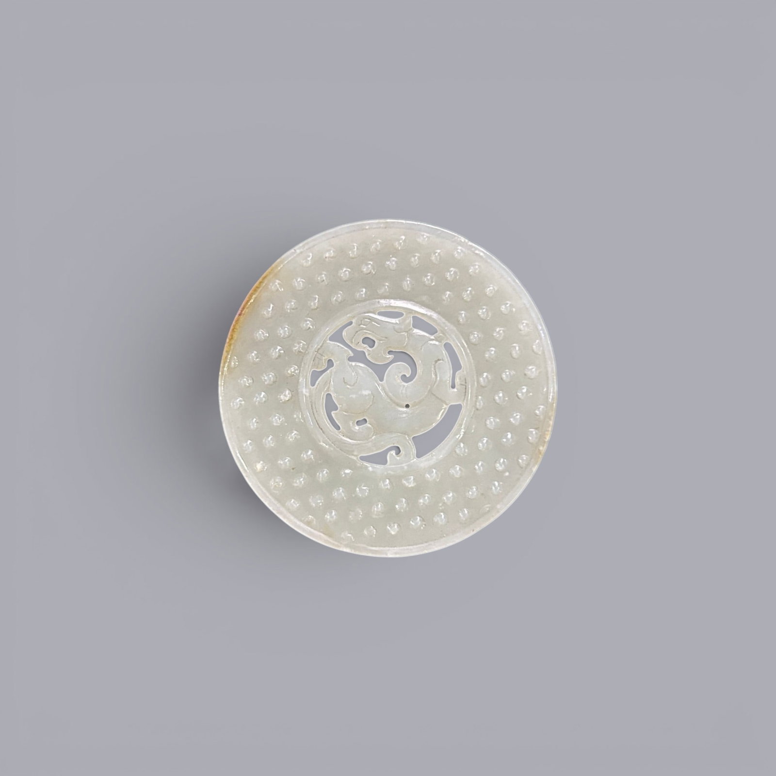Chinese Art, A Jade Bi Disc Decorated with Dragons, 3rd Century BC-3rd Century AD, Han Dynasty: Chinese Art, A Jade Bi Disc Decorated with Dragons, 3rd Century BC-3rd Century AD, Han Dynasty, Diameter 6.3 cm.