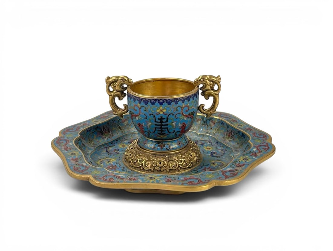 A Gilt Cloisonné Enamel Cup and Saucer Decorated with the Character 'Shou', 18th Century, Qing: A Gilt Cloisonné Enamel Cup and Saucer Decorated with the Character 'Shou', 18th Century, Qing Dynasty, Cup: Height 5 cm, Diameter 6 cm, Saucer: Diameter 19 cm Condition Report:good condition, no iss