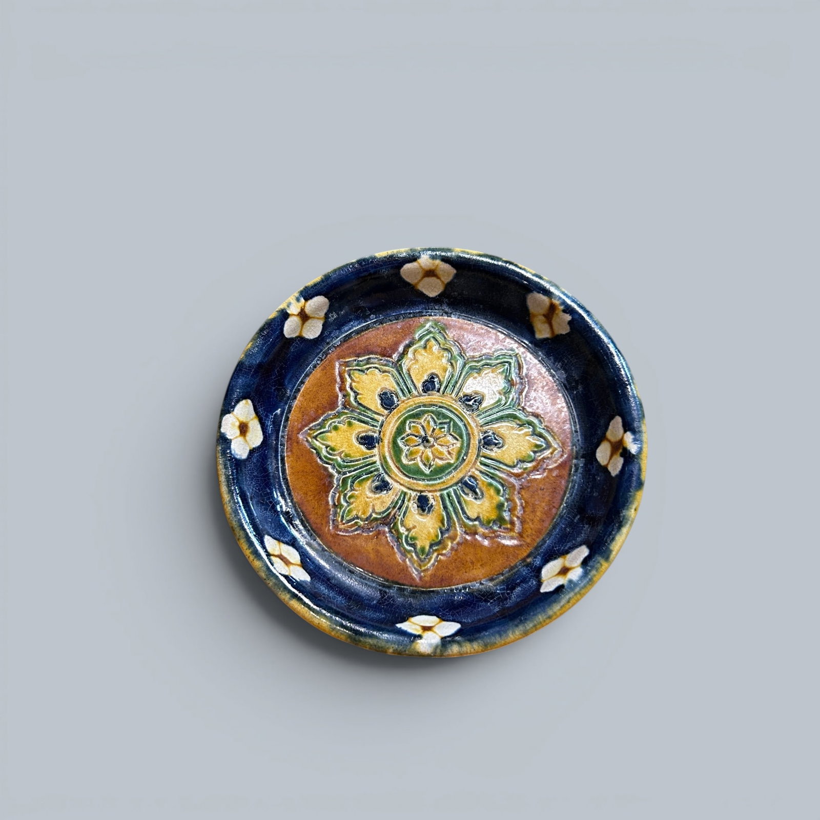Chinese Art, A Sancai Dish, 7th–10th Century, Tang Dynasty: Chinese Art, A Sancai Dish, 7th–10th Century, Tang Dynasty, Height 2 cm, Diameter 12 cm.