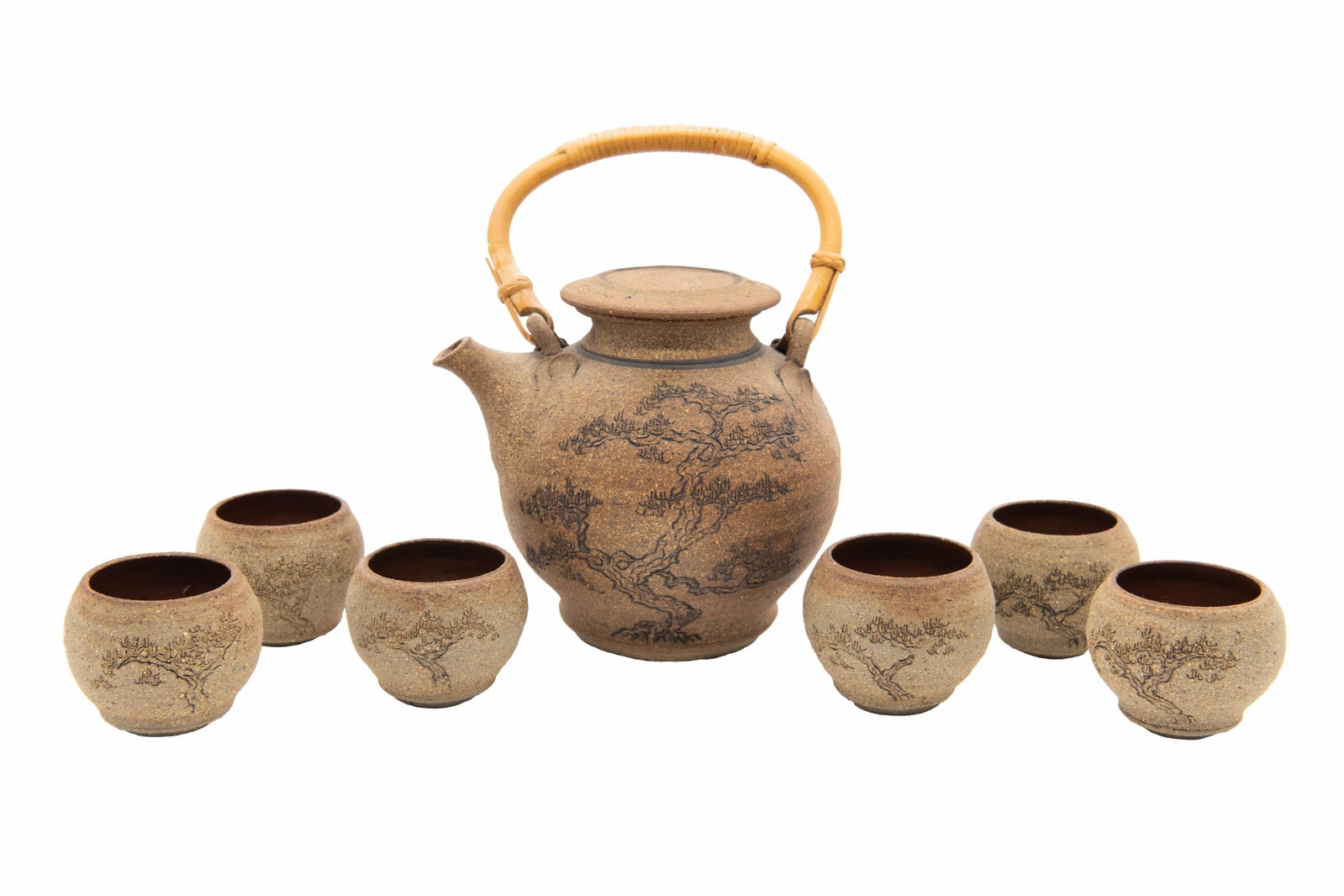 Japanese Earthenware Tea Set with Carved Bonsai Design: Japanese Earthenware Tea Set with Carved Bonsai Design 1 x Teapot with Bamboo Handle Approximate Size: 6.5” H x 6” W x 6.5” D 6 x Teacups Approximate Size: 2.25” H x 3” W