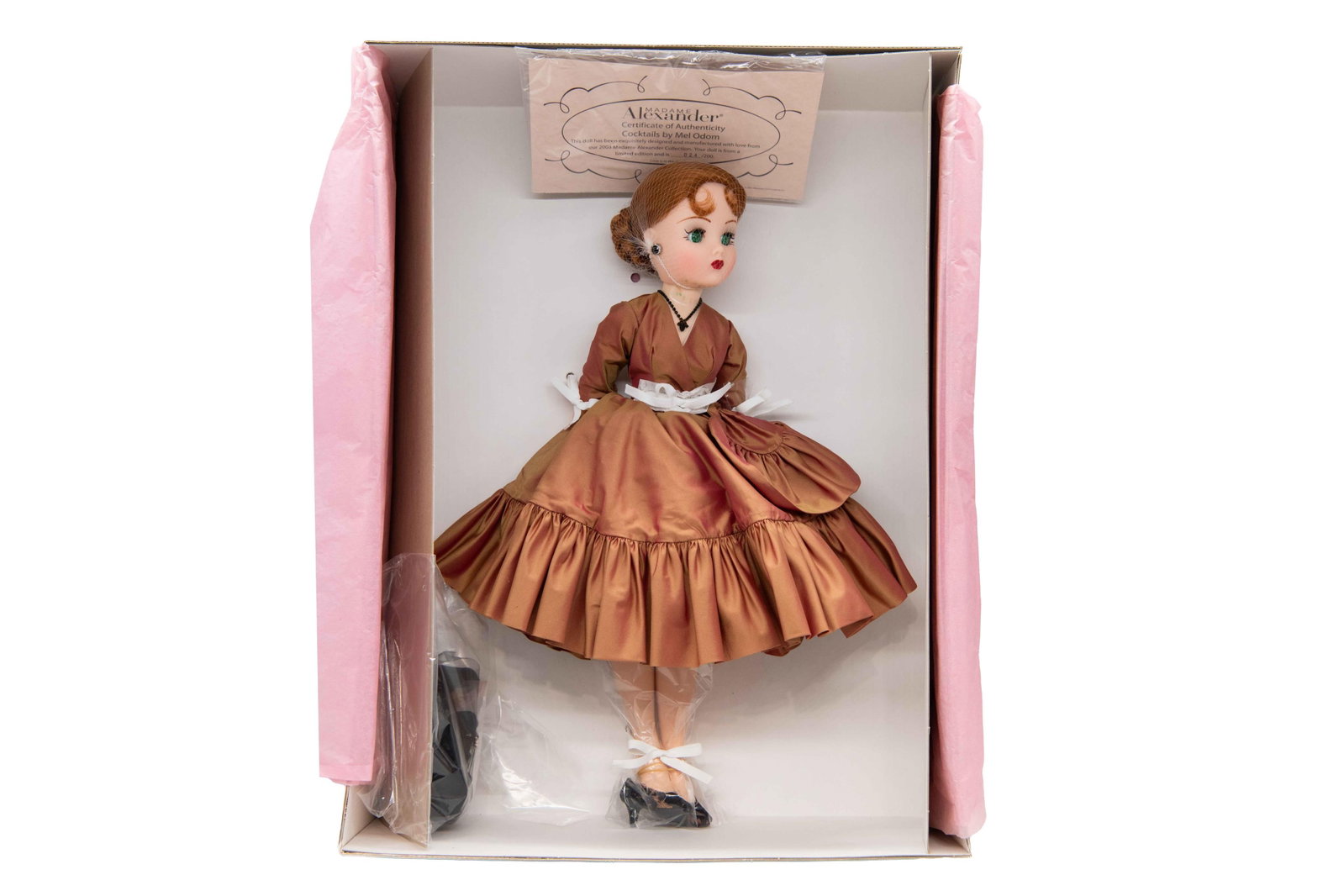 Madame Alexander ‘Cocktails by Mel Odom’ 36070 Doll, 2003: Madame Alexander ‘Cocktails by Mel Odom’ 36070 Doll, 2003 Includes Certificate of Authenticity. Numbered 024/200. Box has minimal wear with minor creases and scuffs commensurate with age. 