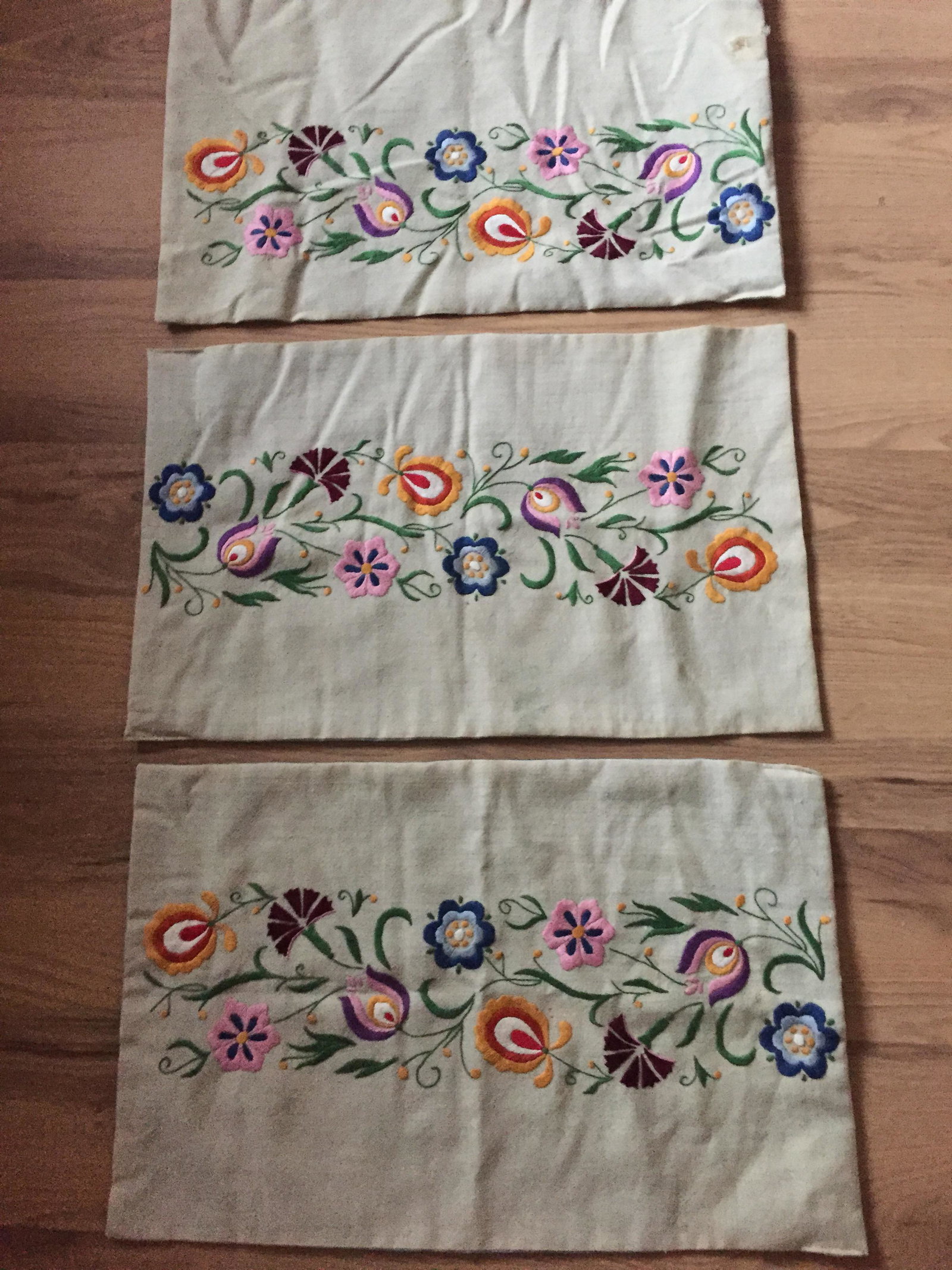 Antique Eastern European Embroidered Pillowcases: Antique embroidery on wool.