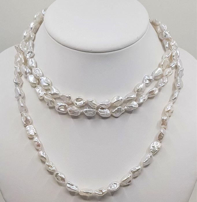 925 Silver - 8x9mm Keshi Freshwater Pearls - Long: A long pearl necklace of keshi Freshwater pearls, that shimmers with iridescence as it catches the light and is finished with a secure sterling silver clasp.Each of these pearls has a unique baroque s