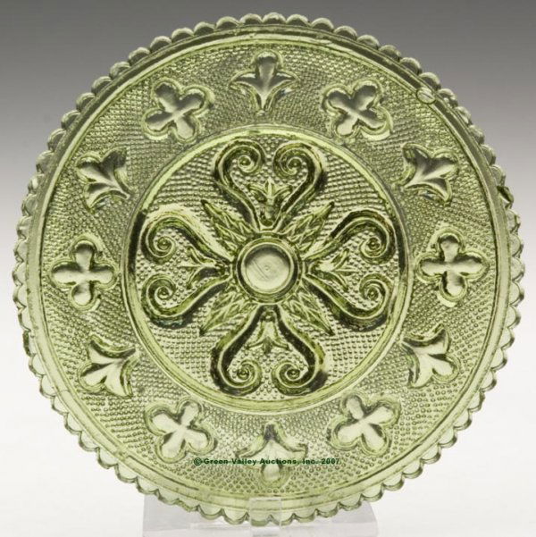 LEE/ROSE NO. 263 CUP PLATE, olive green, 66 even: LEE/ROSE NO. 263 CUP PLATE, olive green, 66 even scallops. Rare. Possibly Boston & Sandwich Glass Co. 3 5/16" d. Provenance: Collection of Anne and the late Leon Powell. Abraham & May, 3/73, $81.