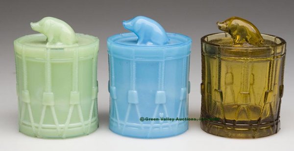 PIG ON DRUM COVERED JARS, LOT OF THREE, opaque blu
