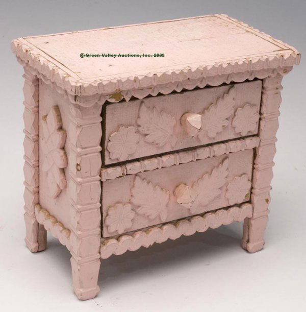TRAMP ART CHILD'S TWO-DRAWER CHEST, ornamented wi: TRAMP ART CHILD'S TWO-DRAWER CHEST, ornamented with bold chip carvings and applied elements, later pink paint. Late 19th/early 20th century. 10 3/4" h, 6 1/2" x 11 3/4" Reference: From a Shenandoah Va