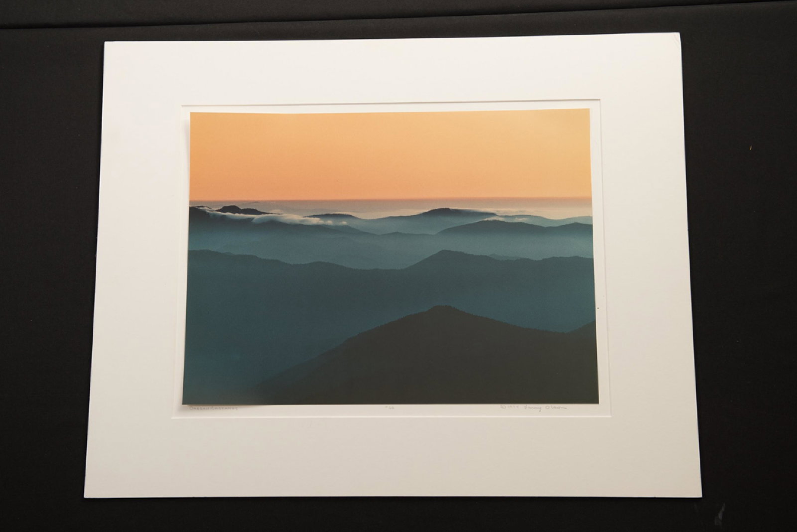 Larry Olson, "Oregon Cascades", Photograph: Larry Olson, "Oregon Cascades"; Colored photograph; Dated 1974; Numbered 68; Signature on bottom right; Unframed; Visible area measures approximately H 14 inches x W 19 inches; Outer dimensions measur