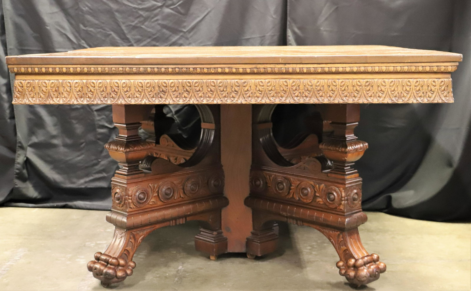 Dining Table: Expanding wood table; Ornately carved legs and sides; Features drop down center leg when expanded; Measures approximately H 29 1/2 x W 53 x D 48 inches; Table leaves are missing; Nicks on table top an