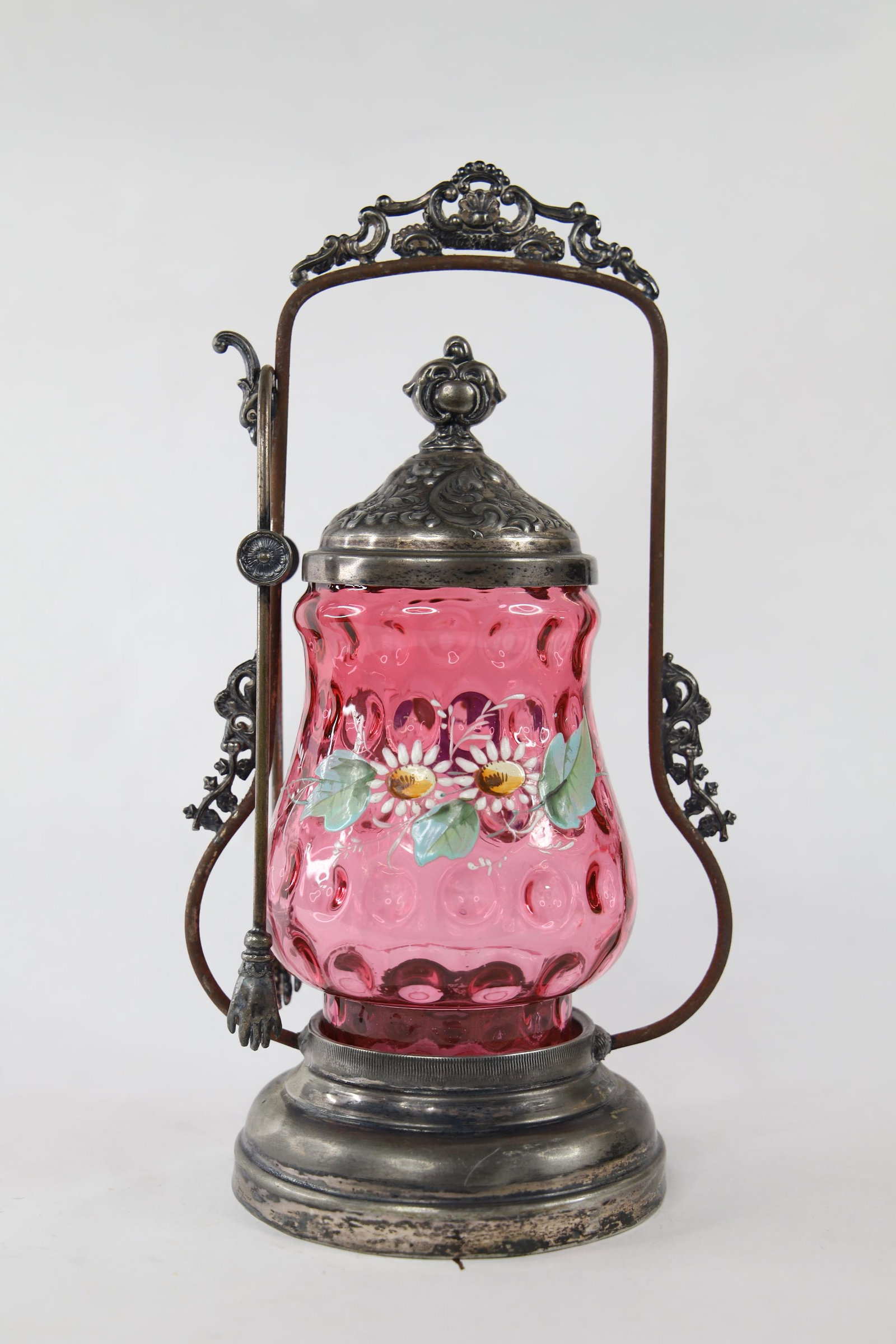 Cranberry Glass Pickle Castor: Handpainted cranberry glass with silver toned castor and tongs; Measures approximately H 10 1/2 x W 5 1/2 x D 4 1/4 inches; Castor handle is damaged and disconnecting from base; Tarnishing all over. S