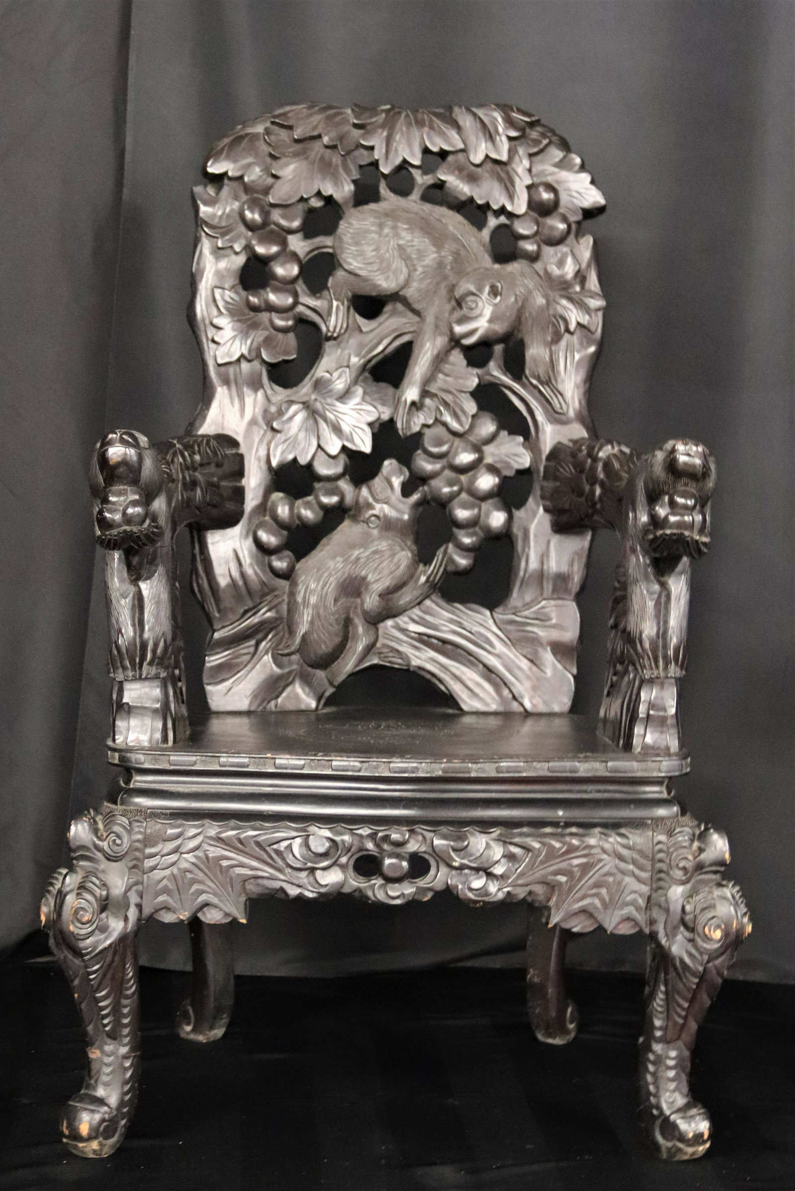 Post-Victorian Era, Asian, Carved Wood Armchair: Post-Victorian era, Asian made for export, hand carved wooden armchair with monkey design; Measures approximately H 44 1/2 x W 29 1/2 x D 20 inches; Nicks and scratches on feet and chair back. See pho