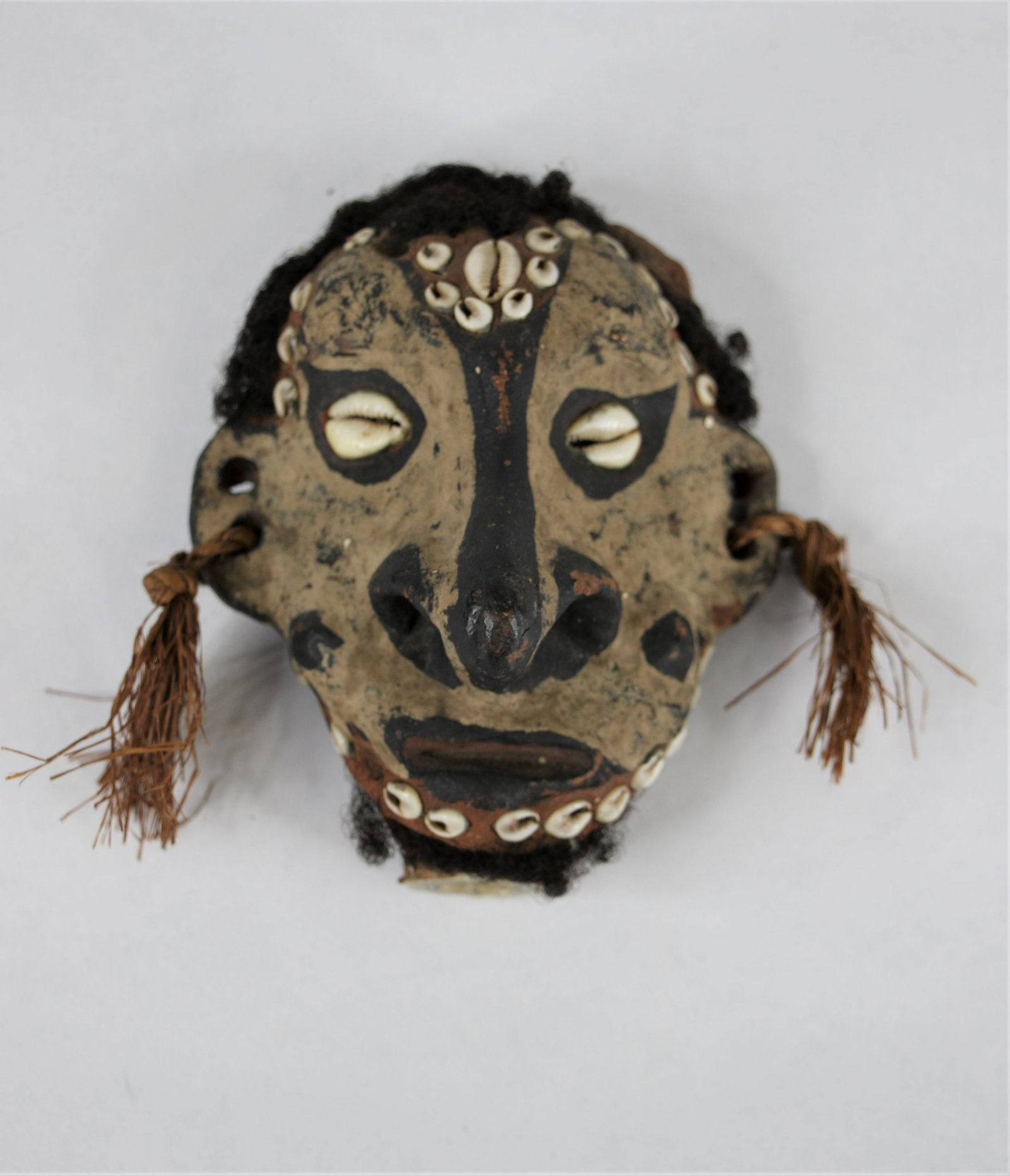 Papau New Guinea Scepter Head: Clay mask affixed to a piece of bone to be attched to the top of a scepter; Features human hair and seashell detailing; Measures approximately H 6 1/2 x W 4 1/2 x D 3 inches; Signficant wear all over.