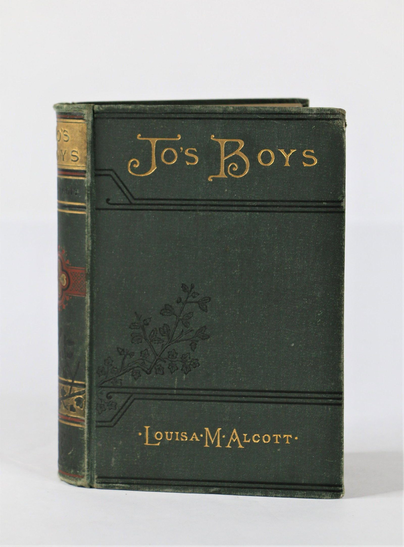 Louisa May Alcott, 1886 Hardcover Book: Jo's Boys by Louis May Alcott; Hardcover book; Copyright 1886; Cloth bound; Includes illustrations; Measures approximately H 7 x W 5 x D 1 1/2 inches; Wear on edges; Spine intact; Some staining on pag