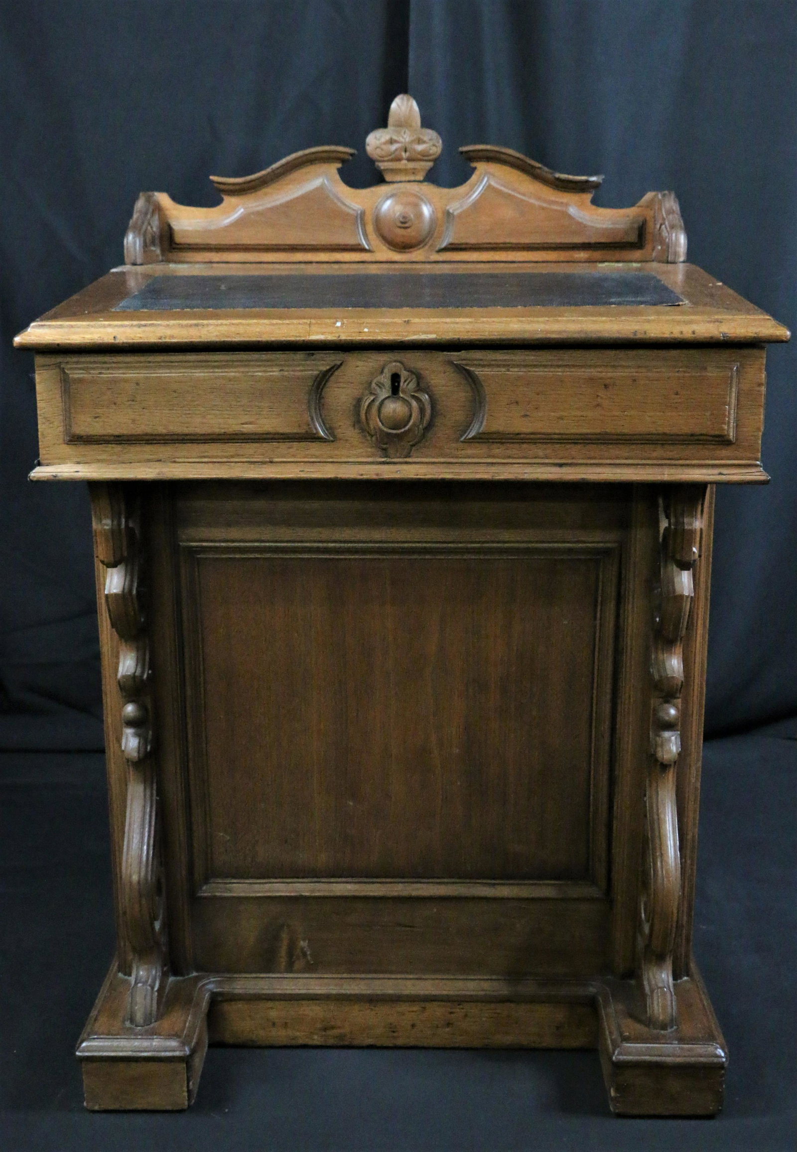 Davenport Desk: Wooden davenport desk with leather writing surface; Three drawers with locks and brass hardware on right side; three faux drawers on left side with faux locks and brass hardware; Measures approximatel