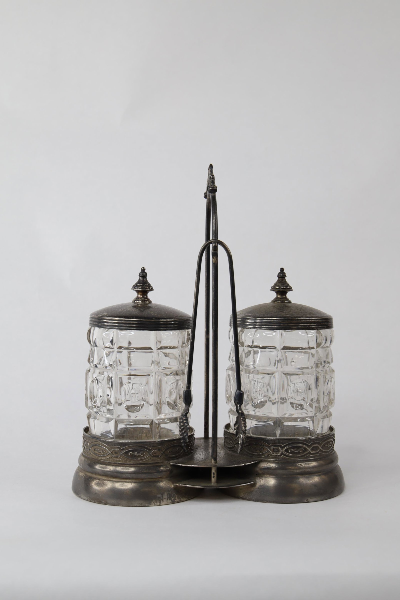 Rockford, Double Pickle Castor: Silver double glass pickle castor with tongs; Bottom is marked "Quadruple Silver Co 653 Rockford"; Measures approximately H 10 x W 9 x D 4 inches; Noticable tarnishing all over. See photos