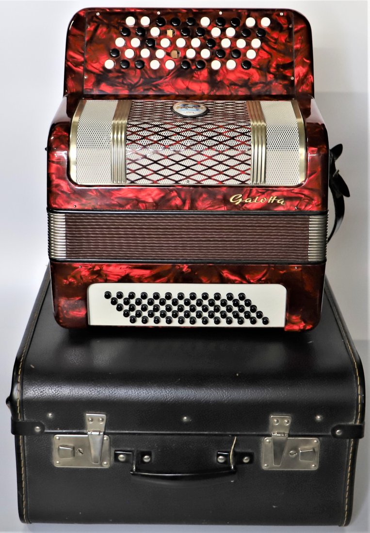 Galotta Accordion with Carrying Case: Galotta accordion, marked 1909. Missing buttons on the accordion. No other visible damage. Operational condition unknown. Matching carrying case. Accordion measures H 12 1/2 x W 14 x D 8 inches (locke