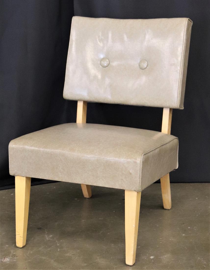 Mid Century Modern Slipper Chair: Vinyl and wood chair with upholstery tacks on back; No makers mark; Measures approximately H 31 1/2 x W 19 3/4 x D 22 inches; Wear on legs; Minor wear on top edge of vinyl on the back. See photos