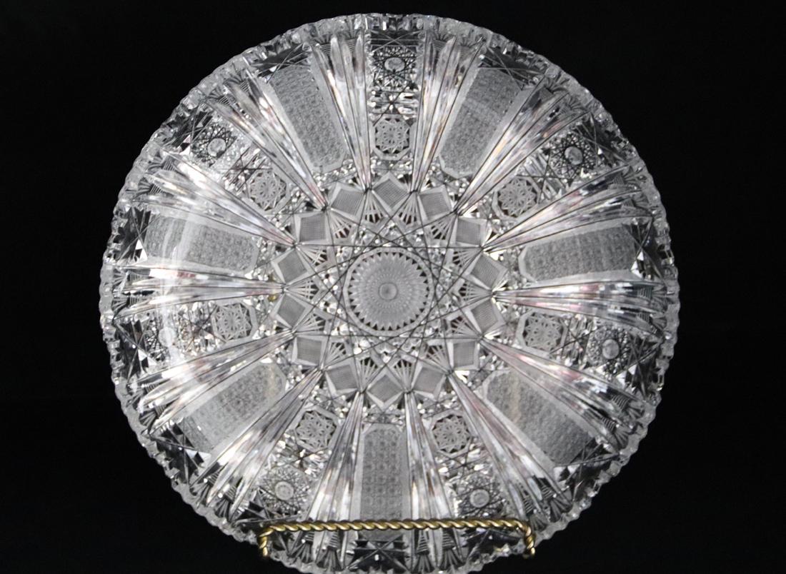 Eastern European Brilliant Cut Glass Bowl: Shallow serving bowl with saw tooth edge; Measures approximately H 2 x 11 1/4 inches diameter across the top; No visible makers mark; Chip in saw tooth edge. See photos