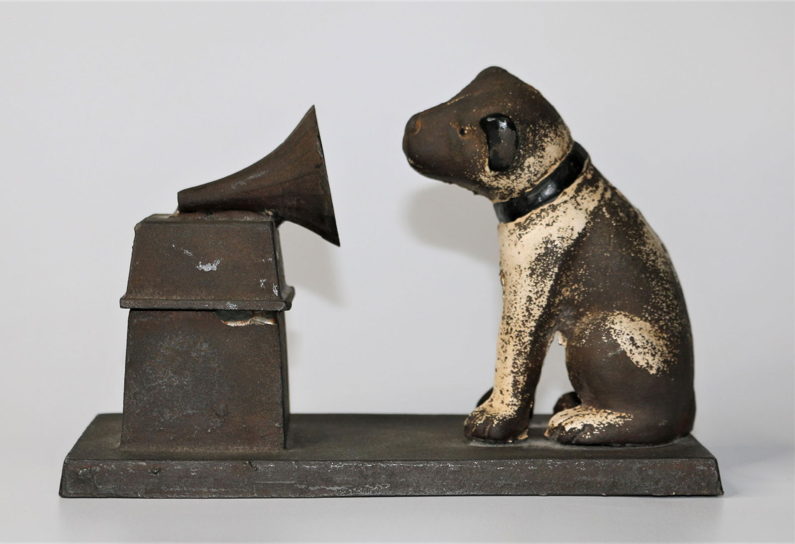 Vintage Cast Iron RCA Dog: Painted cast iron RCA Dog and Gramophone figurine; No maker's mark observed; A small "B" is engraved on the bottom; Measures approximately H 4 3/4 x W 8 x D 3 1/2 inches; Most of the paint has worn of