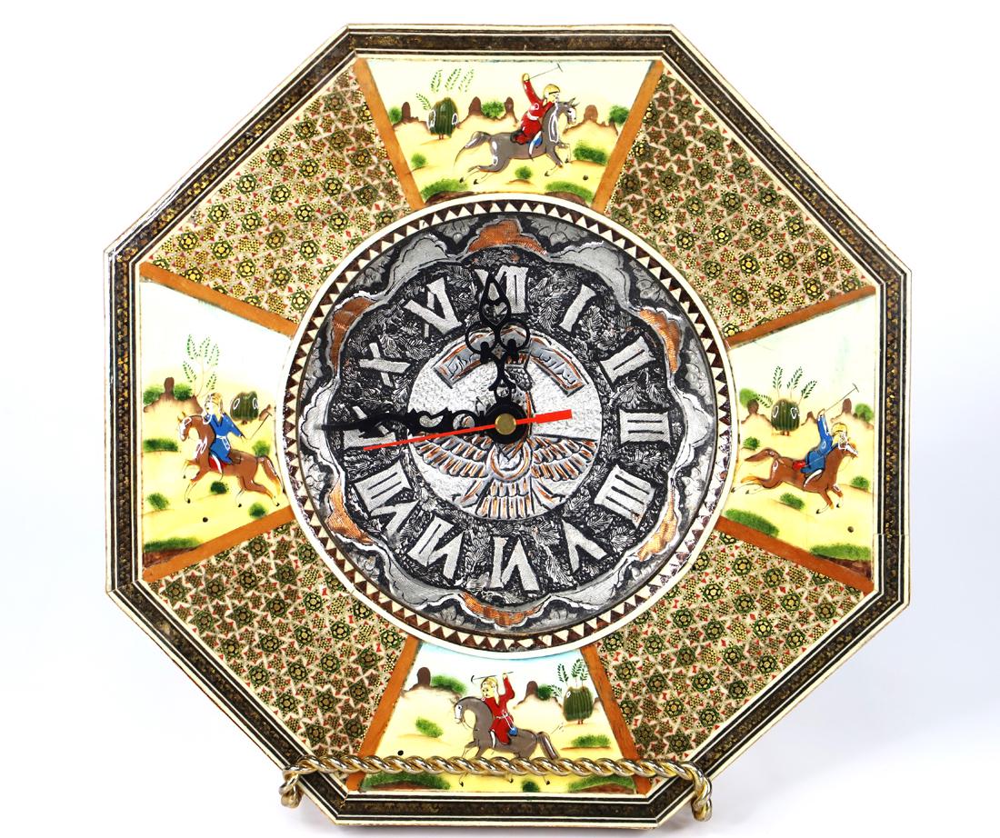 Khatam Kari, Wall Clock: Persian Khatamkari wall clock with wood and enamel; Face is a silver toned metal; Battery operated; Measures approximately H 10 x W 10 x D 1 1/2 inches; Scratches and chipping on the wood. See photos